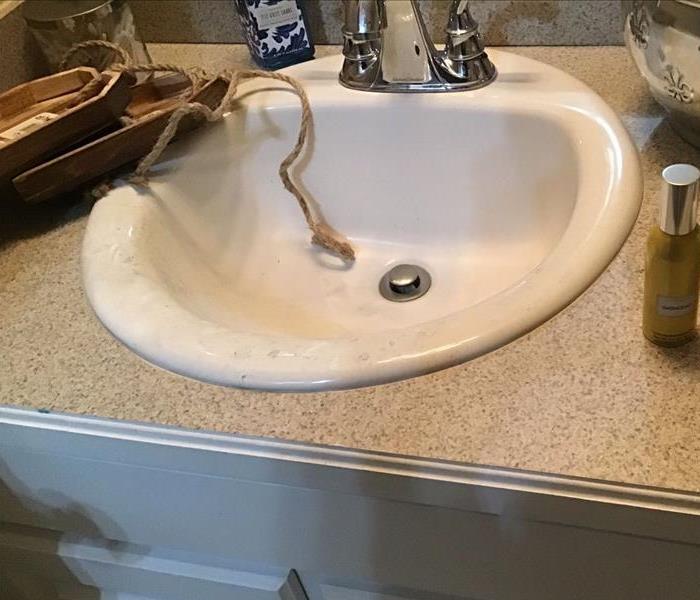 A bathroom sink with soot damage